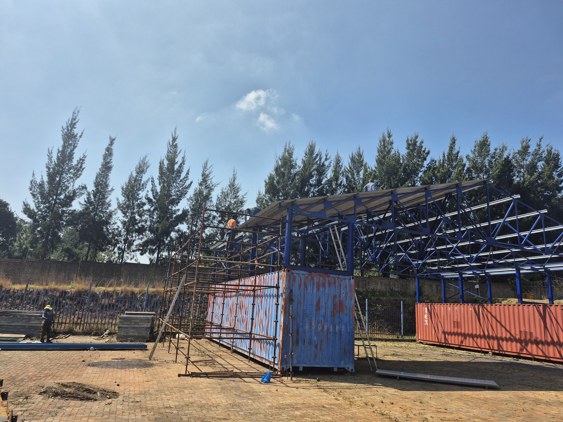 Steel frame going up over the containers